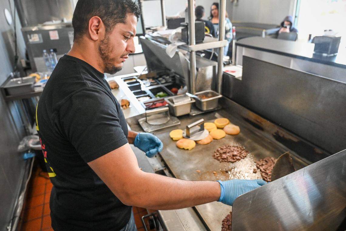 Hamzah “Hammy” Ahmed, owner of Hammy’s Smash Burgers, prepares smash burgers at the grill of his restaurant in this 2022 file photo.