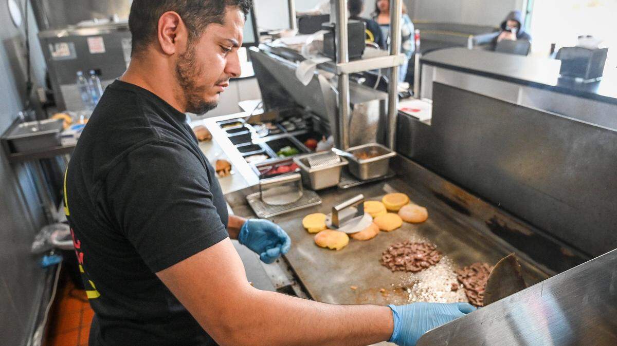 Hamzah “Hammy” Ahmed, owner of Hammy’s Smash Burgers, prepares smash burgers at the grill of his new restaurant in this 2022 file photo.