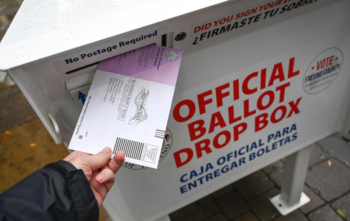 An election ballot is dropped off at a downtown Fresno voting drop box prior to Tuesday’s general election, on Monday, Nov. 7, 2022.