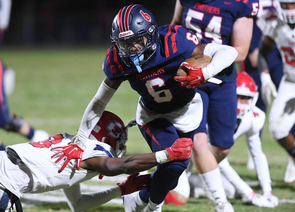 San Joaquin Memorial’s Donovan Harris kicks through Sanger’s last chance as Harris runs the ball in for a touchdown Friday, Oct. 28, 2022 in Fresno. Memorial led 28-14 at halftime.