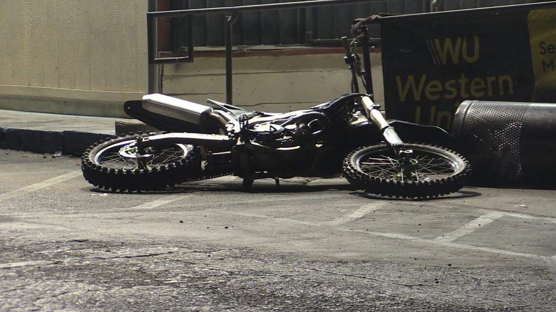 A dirt bike lays by a Fresno, California liquor store on Friday, July 12, 2024 following a deadly collision.