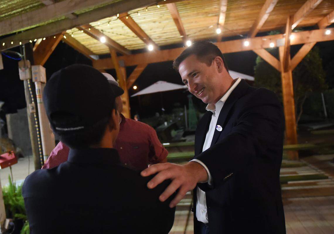 District 7 city council candidate Brian Whelan, right, talks to supporters at Gazebo Gardens late Tuesday night, Nov. 6, 2018 in Fresno.