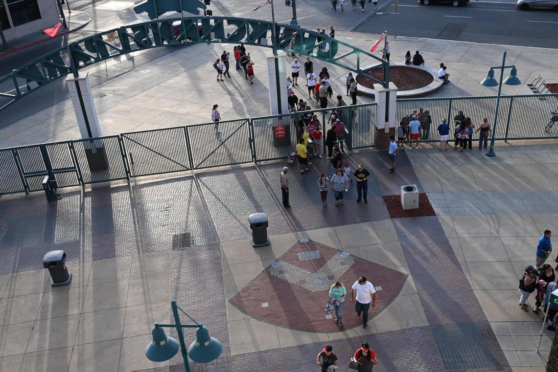 Baseball fans slowly flow through the main gate at the Fresno Grizzlies season opener against the Stockton Ports Friday, April 8, 2022 at Chukchansi Park in Fresno.