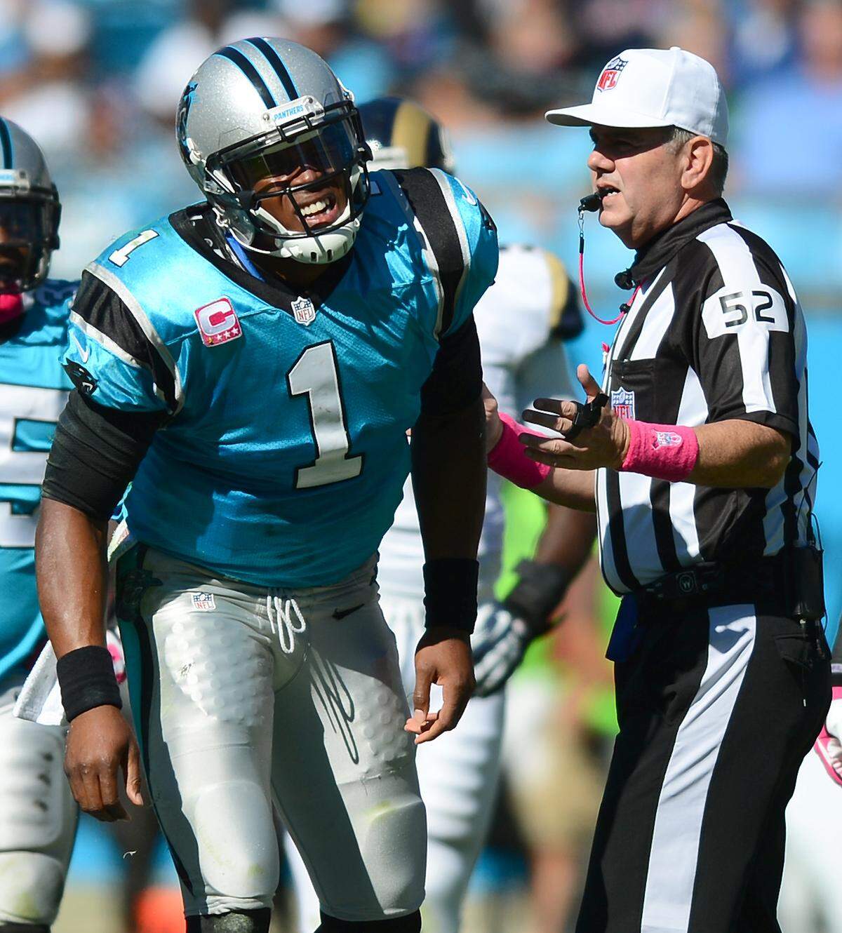 Carolina Panthers (1) quarterback Cam Newton grimaces as he gets up from the turf after being hit by (94) defensive end Robert Quinn during third quarter action on Sunday, October 20, 2013 at Bank of America Stadium in Charlotte, NC. The Panthers defeated the Rams 30-15. Looking on at right is (52) referee Bill Vinovich. Jeff Siner - jsiner@charlotteobserver.com