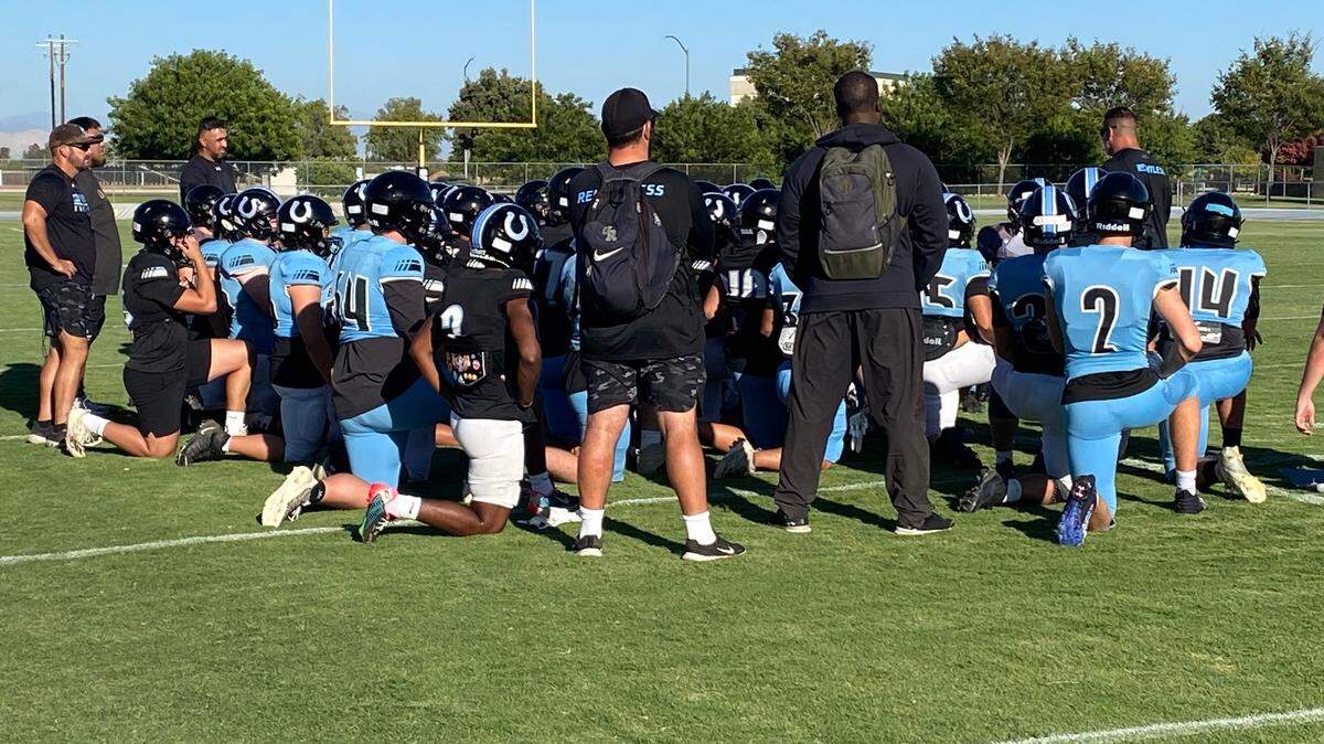 Mike Jacot talks to his Clovis North football team.