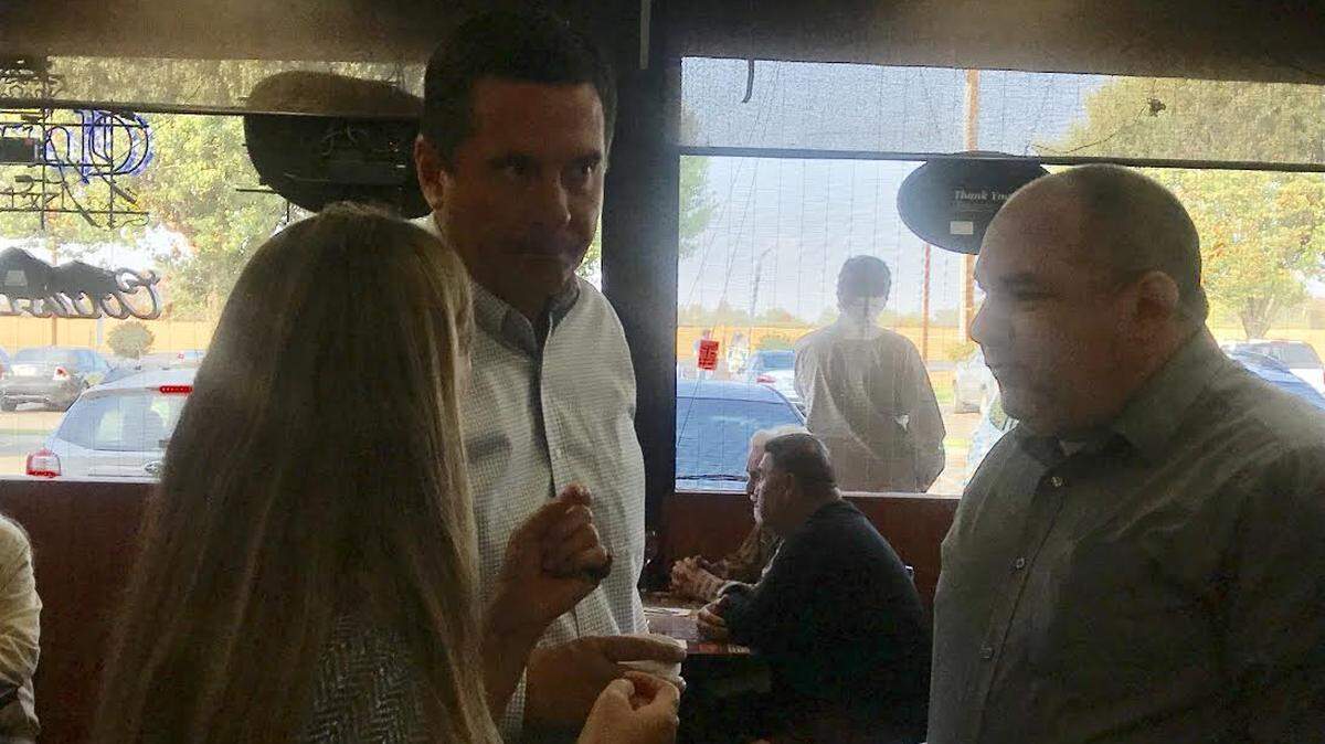 Congressman Devin Nunes, middle, talks to constituents at the Red Caboose Cafe in Clovis on Friday morning.