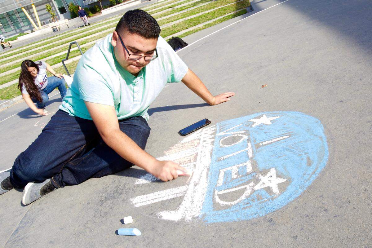Students with Mi Familia Vota draw chalk Get Out The Vote slogans on Edison High School’s main quad on Thursday, Nov. 1, 2018. When a group of 40-or-so Edison students were asked if the upcoming midterm elections were important, fewer than 10 raised their hands in the affirmative.