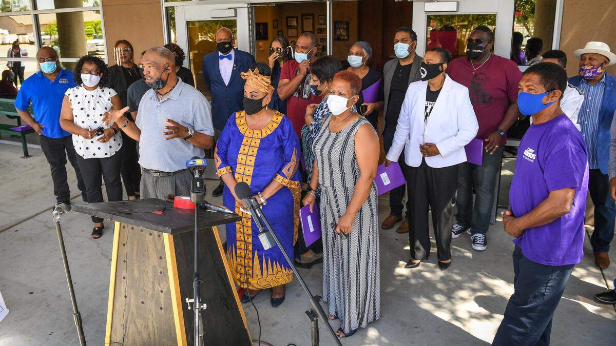 A group of about 30 African American community leaders gathers in front of the Rev. Edward L. Swillis Neighborhood Youth Center in west Fresno on Friday, June 19, 2020 to honor Juneteenth. Each gave statements against racism and a vision for justice, equality and a better quality of life for Blacks in Fresno.