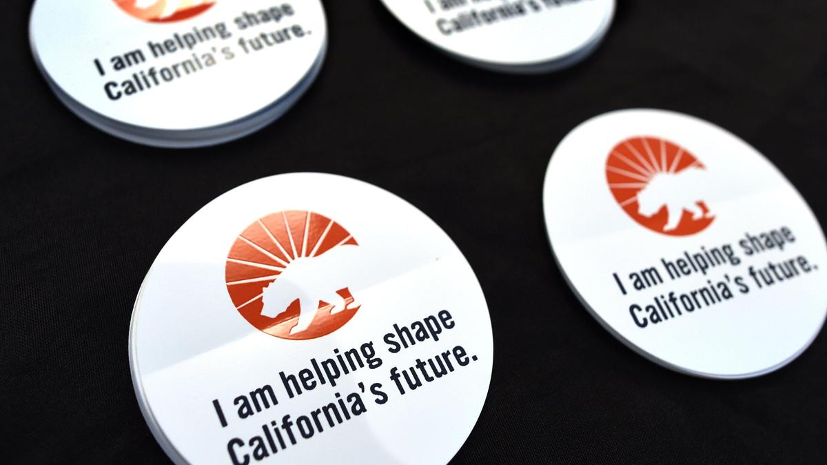 Give-away stickers to promote the application process of the chance to serve on the 2020 Citizens Redistricting Commission are shown at a news conference held by Stephanie Ramirez-Ridgeway, chief council for California State Auditor’s office, at the Betty Rodriguez Regional Library in Fresno, California on Tuesday, June 11, 2019.