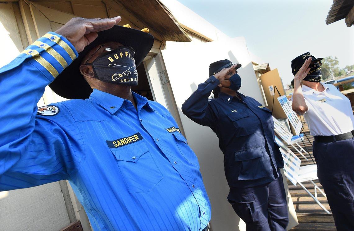 Members of the African American Network of Kern County Buffalo Soldiers, including Isaac Sandifer, left, salute during the playing of the National Anthem at the rededication of Allensworth State Historical Park, Wed. Aug. 26, 2021.