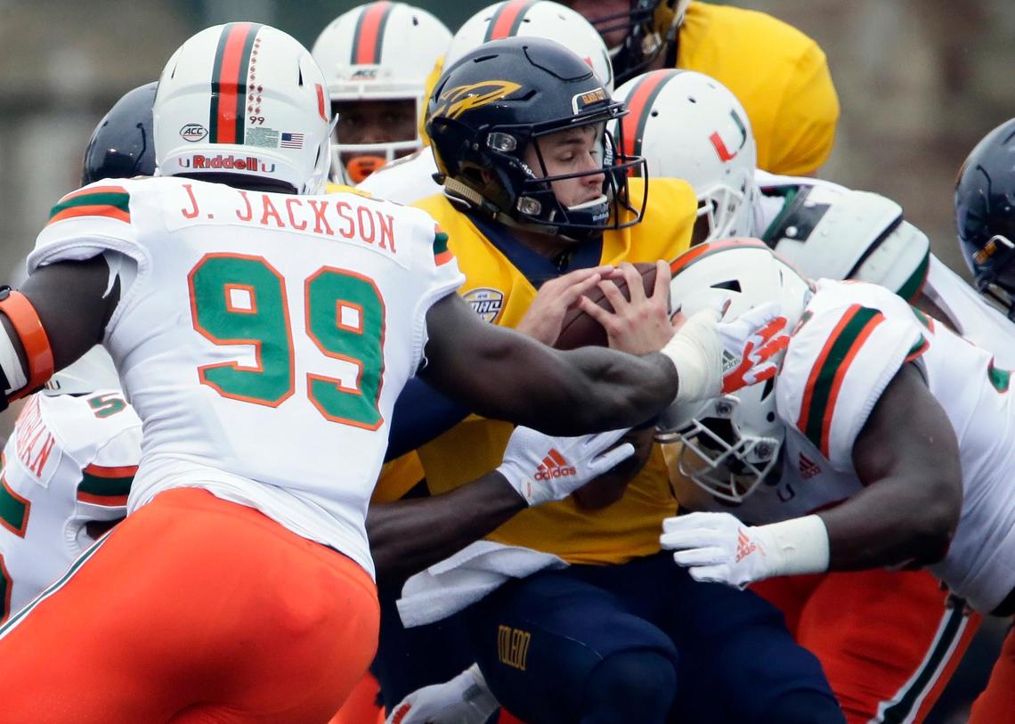 Toledo quarterback Mitchell Guadagni, center, is tackled by Miami defensive lineman Joe Jackson (99) and linebacker Mike Smith, right, during the Rockets’ 49-24 loss to the Hurricanes Saturday, Sept. 15, 2018, in Toledo, Ohio. Guadagni is fourth in the nation in passing efficiency rating at 205.46.