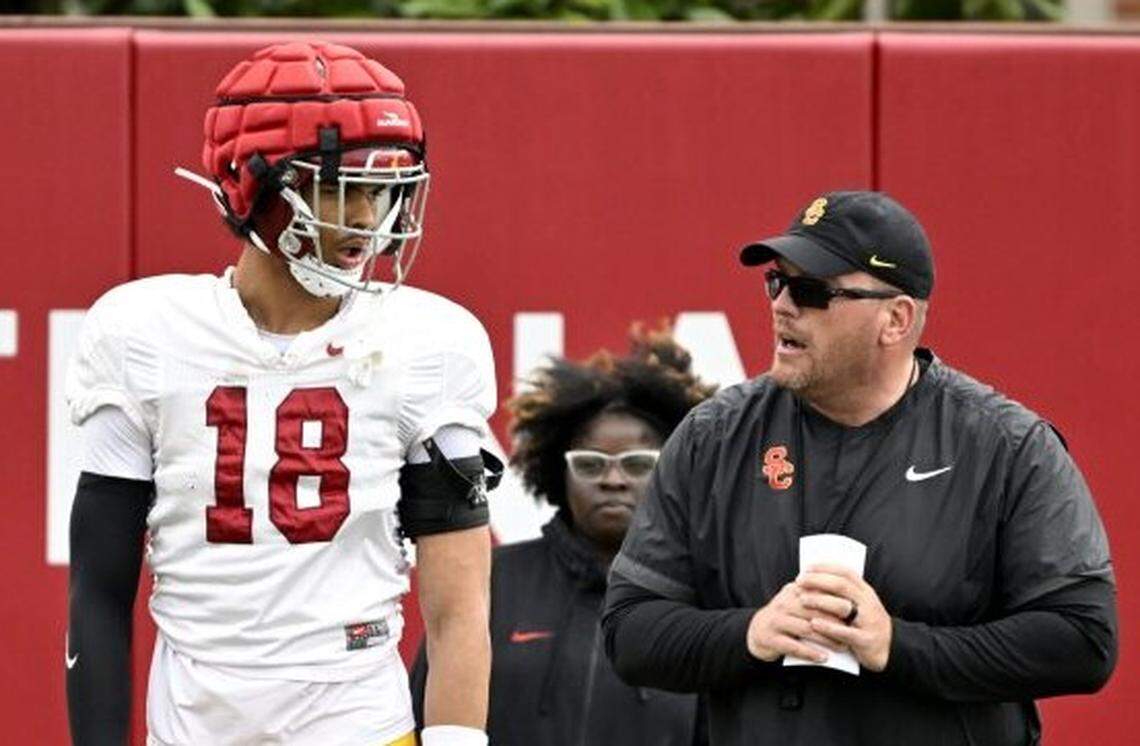 USC senior Eric Gentry, left, speaks with linebackers coach Matt Entz during practice April 4, 2024, at Howard Jones Field.