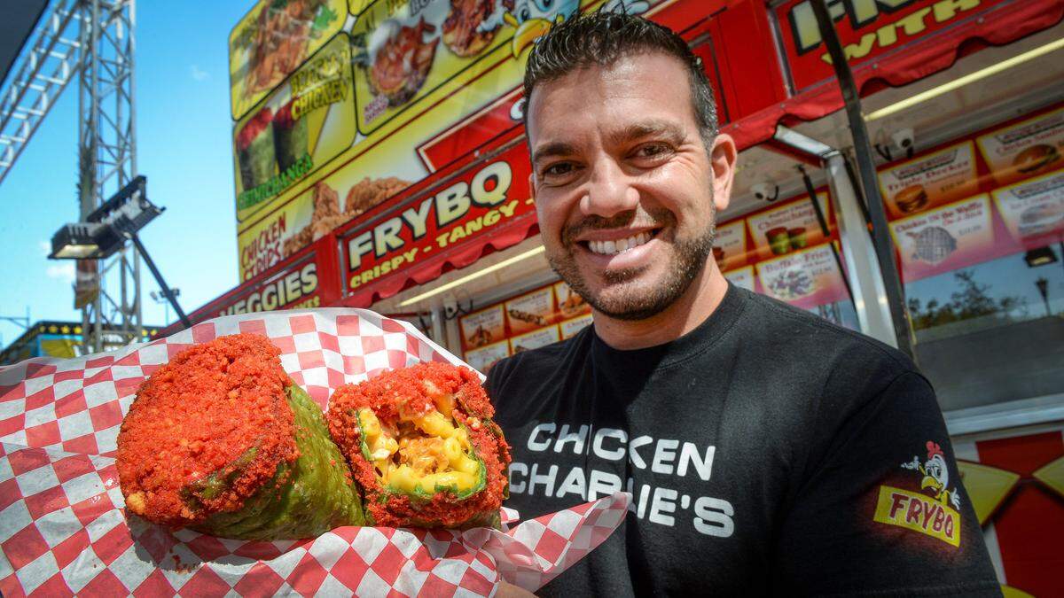 Tony Boghosian of Chicken Charlie’s shows off his latest creation - a buffalo chicken chimichanga - made with Buffalo chicken, bacon, mac and cheese, deep fried in a large spinach tortilla and dipped in Flamin’ Hot Cheetos. The monster chimichanga is served with Buffalo ranch dressing and will be on the menu at this year’s Big Fresno Fair opening on Wednesday.