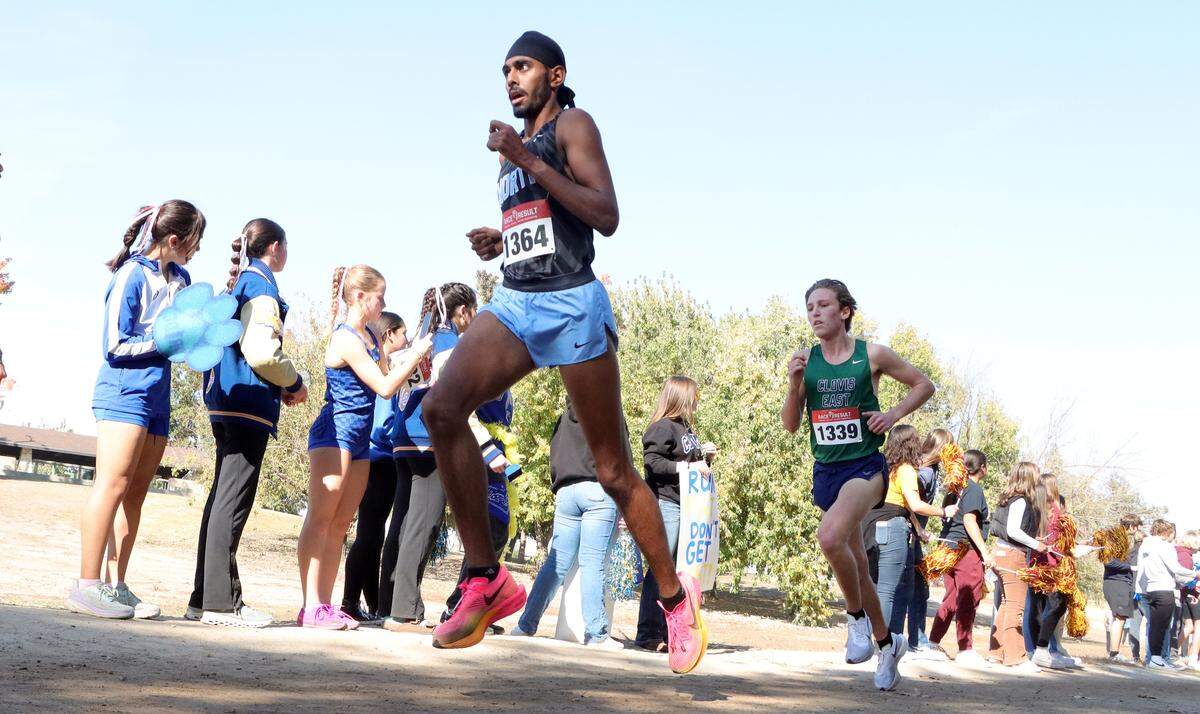 Clovis North senior Teg Pandher leads eventual winner Carter Spradling, a Clovis East senior, with about a mile to go in the TRAC cross country championship at Woodward Park on Nov. 9, 2023. Spradling timed 15:25.42, and Pandher 15:32.1.