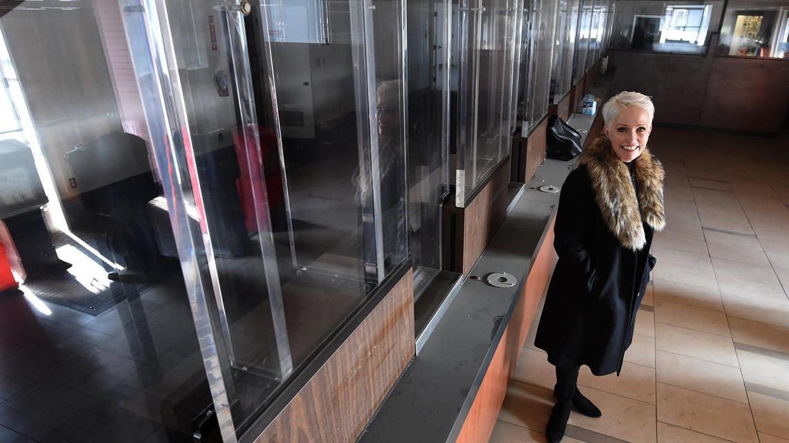 Kacey Auston, a co-owner of the proposed cannabis dispensary called Lemonnade, to be located at the old Bank of America building in the Tower District, stands by a row of former teller windows. The dispensary will focus on edibles.
