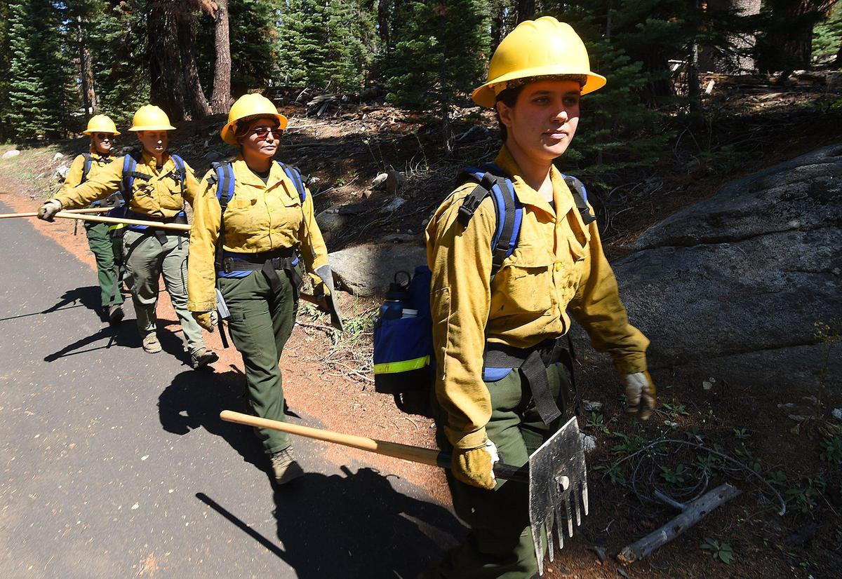 Members of the Yosemite Women’s Fire Internship , led by Guadalupe Ruiz, right, head down Yosemite Creek Campgrounds Road, for back burning training during the County Line Fire, July 14, 2021. The Yosemite Women’s Fire Internship, the first-ever California Conversation Corps internship program of its kind, brings women together for a 10-month intensive program where they learn how to be firefighters and how to protect and manage the landscape with fire. In this internship, they learn key wildfire management skills such as sawing down trees, building piles for fuel removal, and other key skills for fire management.