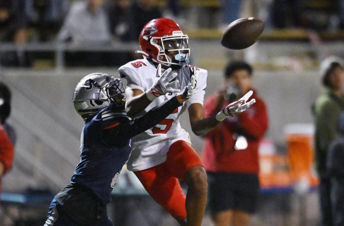 Clovis East’s Landon Nesbitt, left, tangles up interfering with a pass intended for Sanger’s Marquis Cropper, right, on Thursday, Nov. 9, 2023 in Clovis.