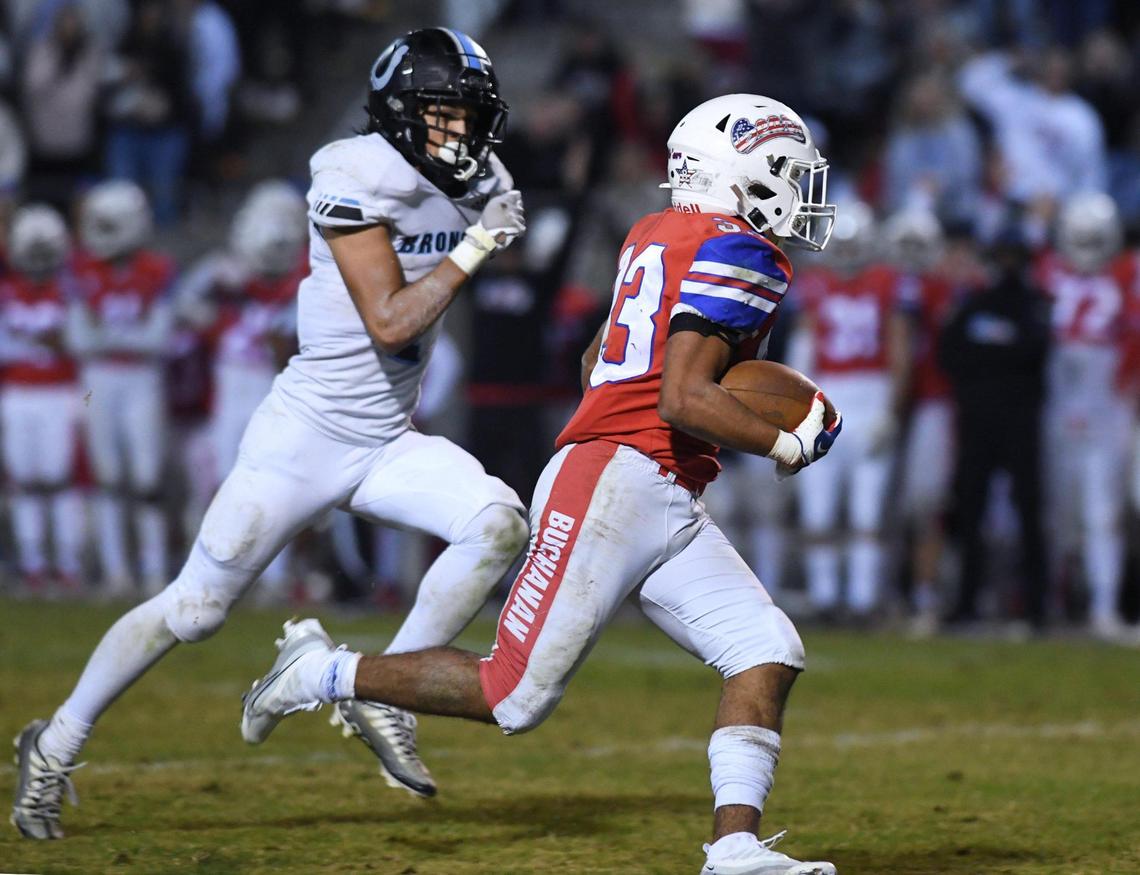 Buchanan’s Michael Runnels, right, is chased by Clovis North’s Vincent Cordoba, as Runnels runs for a touchdown as the Bears go on to defeat Clovis North 37-24 in a Central Section Division I quarterfinal on Thursday, Nov. 10, 2022 in Clovis.