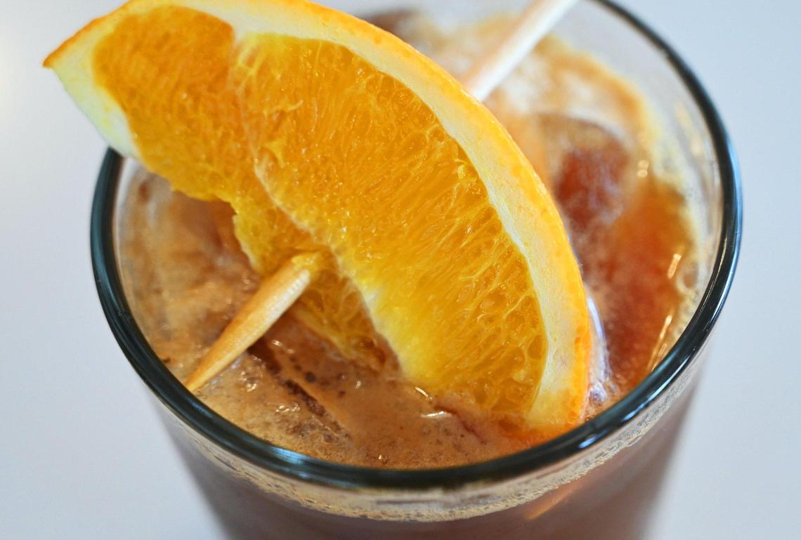 An orange slice tops the espresso tonic at Component Coffee in the Tower District. The drink is made by pouring espresso over tonic water. Photographed Thursday, Jan. 12, 2023 in Fresno.
