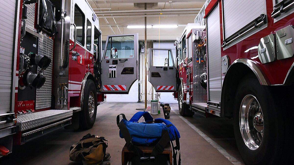 A Fresno Fire Department ladder truck and engine are parked within Fire Station #3 Friday, June 19, 2020 in Fresno.