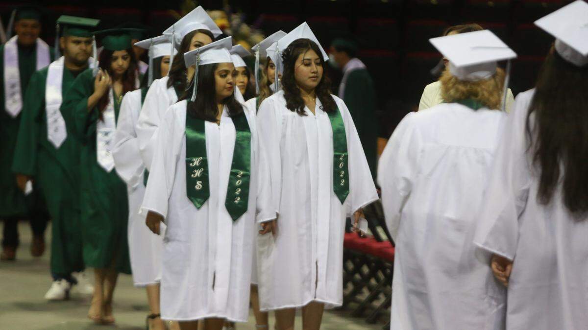 Hoover High School graduates walk into the Save Mart Center during the June 6, 2022, ceremony.