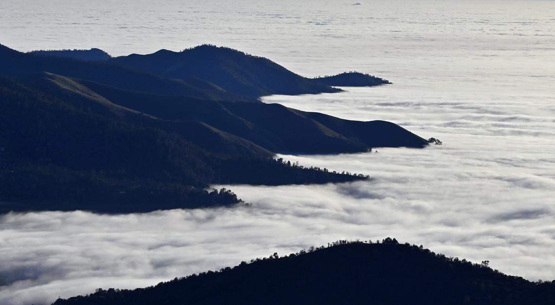 A thick layer of cloud encroaches onto the foothills as it covers the Valley, seen from the 168 “four lane” around the 4,000 foot elevation Thursday afternoon, Dec. 11, 2025 near Prather.
