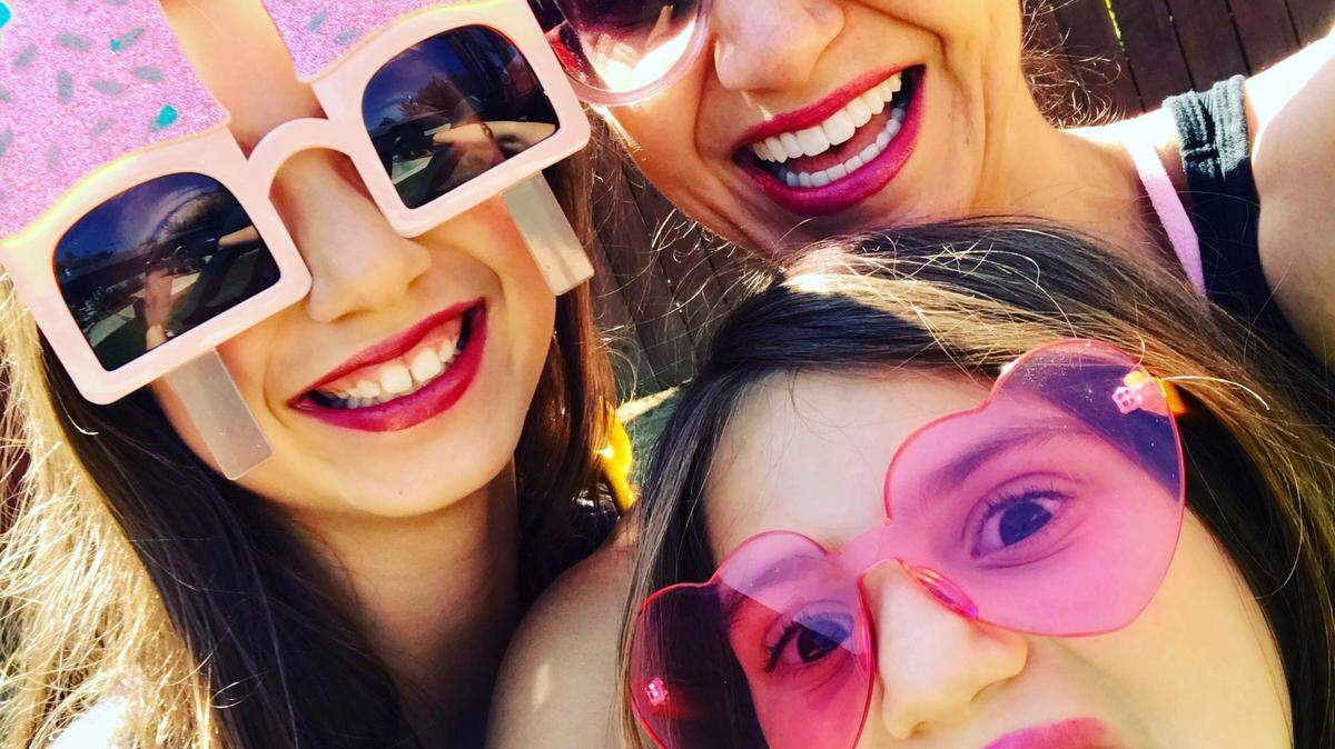 Jill Simonian and daughters enjoy silly time on a summer day.
