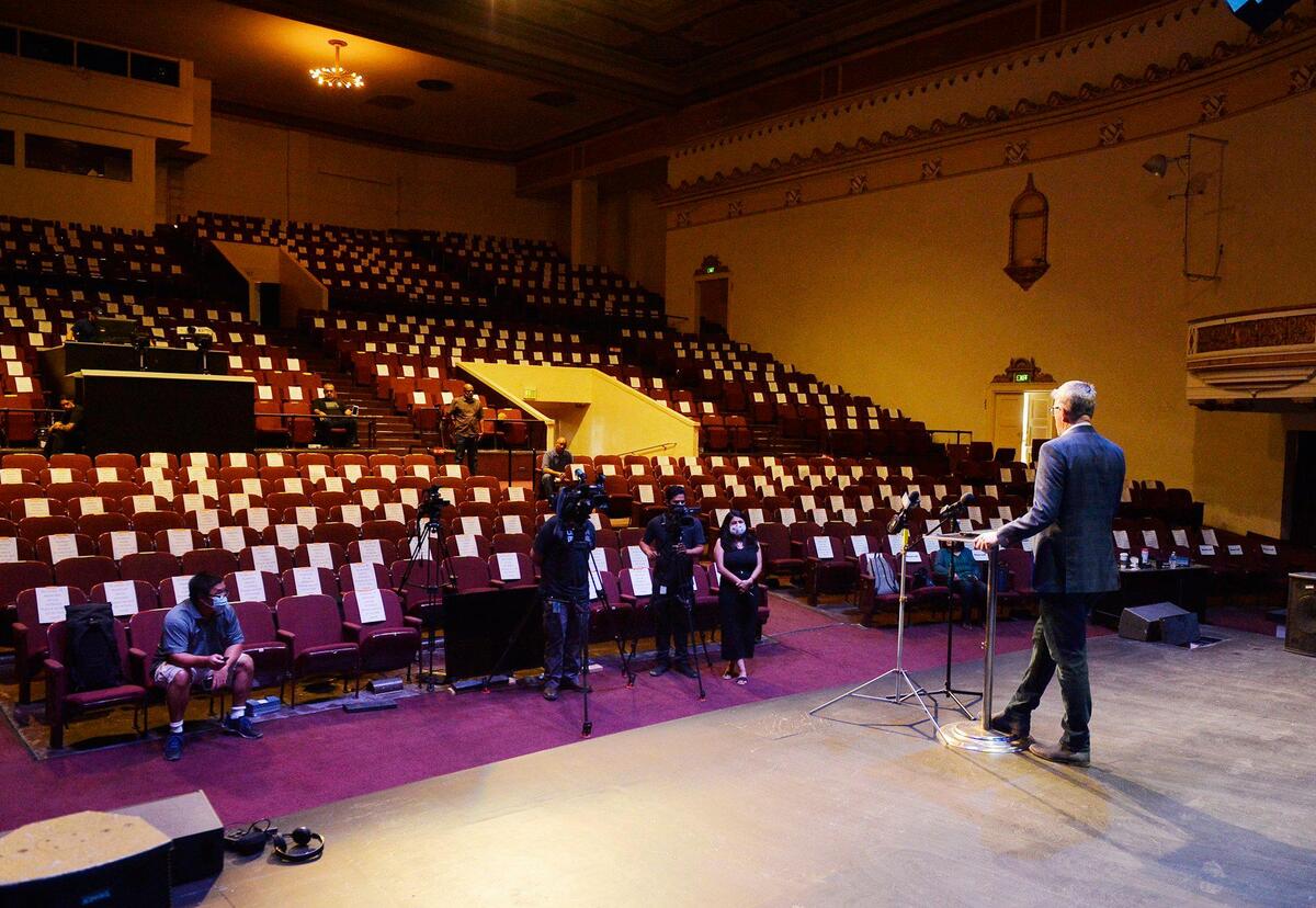 Cornerstone Church Pastor Jim Franklin announces church services will be held the next day, at 25 percent capacity with seats marked excluded from use, seen in background, at a press conference Saturday, May 30, 2020 in Fresno.