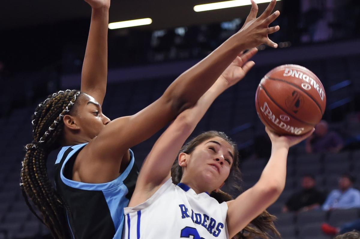 Ramona-Riverside’s Amari Guiton, left, fouls Caruthers High’s Jaque Magana, right, at the CIF state girls DV basketball championship Friday, March 7, 2019 in Sacramento. Caruthers led 42-11 at halftime.