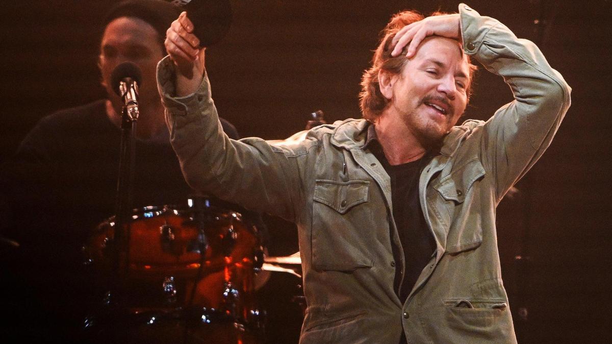 Eddie Vedder of Pearl Jam signals to the crowd while performing with the band during their North American tour stop at the Save Mart Center in Fresno on Monday, May 16, 2022.