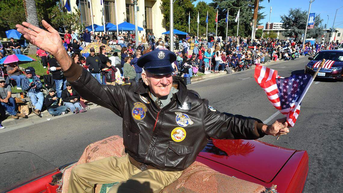 Air Force veteran Bill Dietzel, grand marshal of Fresno’s Veterans Day Parade in 2013, waves to crowds in front of Veterans Memorial Auditorium in downtown Fresno.