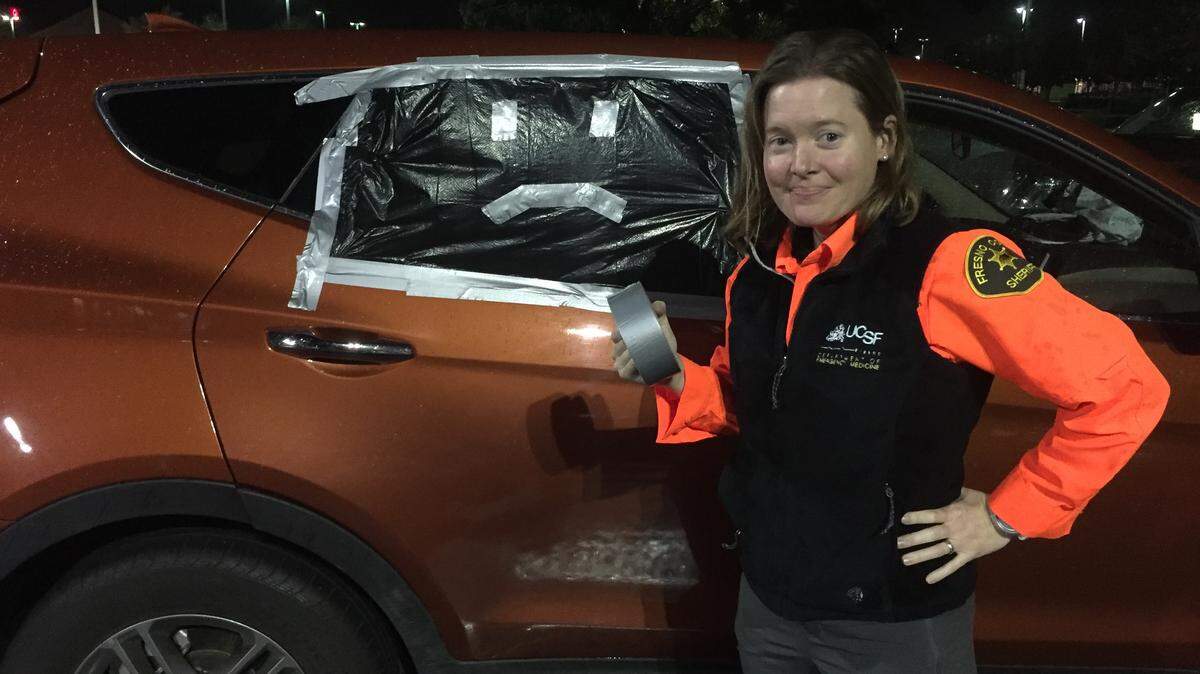 A volunteer with the Fresno County Sheriff’s Office Search and Rescue Mountaineering Team stands beside a shattered SUV window after it was taped up. Equipment was stolen from the vehicle while volunteers were eating dinner in a Turlock restaurant Nov. 23, 2018.