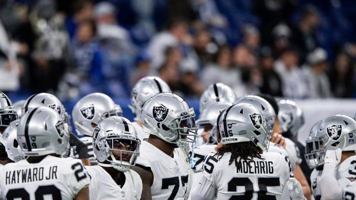 The Las Vegas Raiders huddle on the field before an NFL game against the Indianapolis Colts, Sunday, Jan. 2, 2022, in Indianapolis.