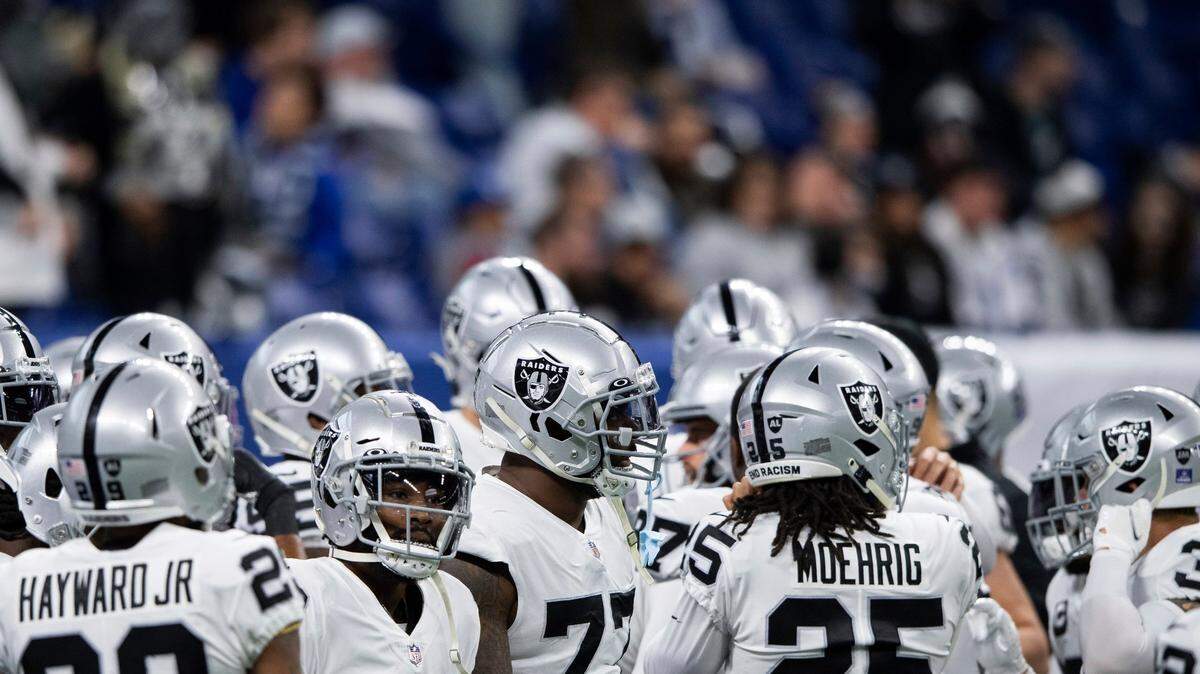 The Las Vegas Raiders huddle on the field before an NFL game against the Indianapolis Colts, Sunday, Jan. 2, 2022, in Indianapolis.
