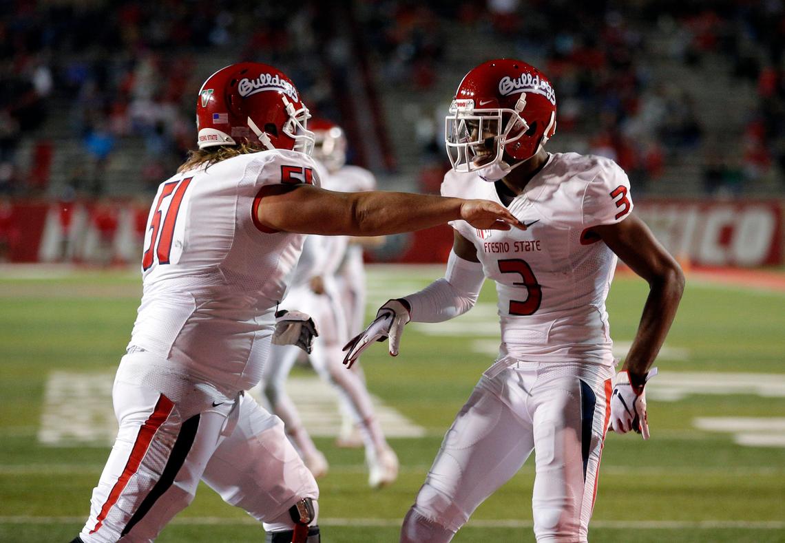 Fresno State wide receiver KeeSean Johnson (3) celebrates with teammate Markus Boyer (51) after scoring a touchdown in the Bulldogs’ 38-7 victory over New Mexico in Albuquerque, N.M., Saturday, Oct. 20, 2018.