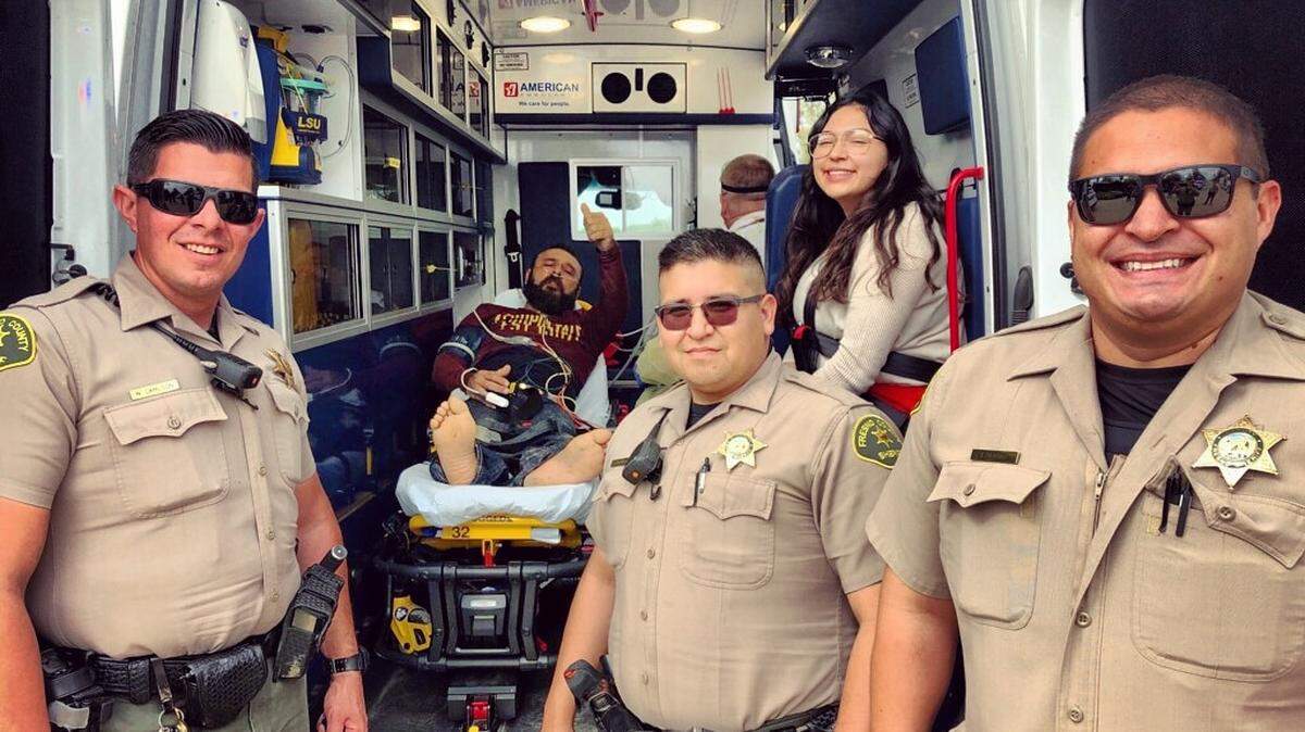 Three deputies with the man they saved from choking on his Easter dinner.