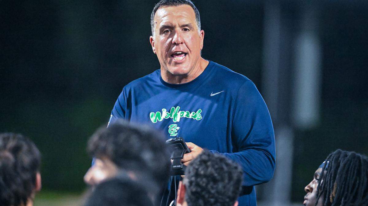 Clovis East head coach George Petrissans talks to his players following their win against Bullard at Lamonica Stadium on Friday, Aug. 22, 2025.