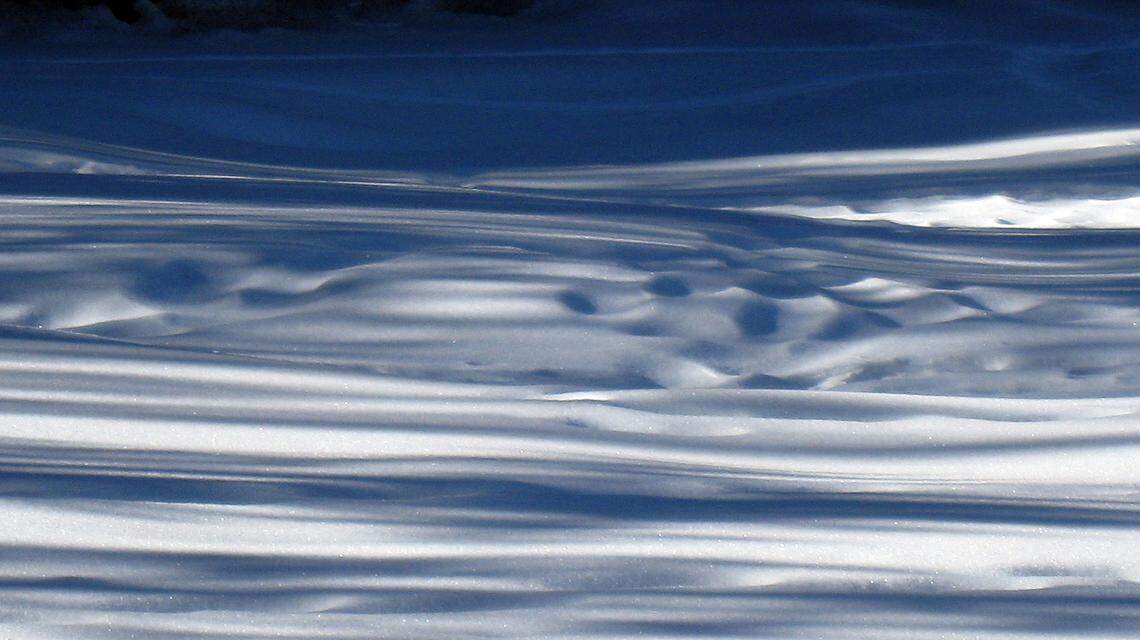 Light and shadow on the snow make for an abstract design in a meadow area on the trail to Dewey Point in Yosemite National Park on Jan. 13, 2009.