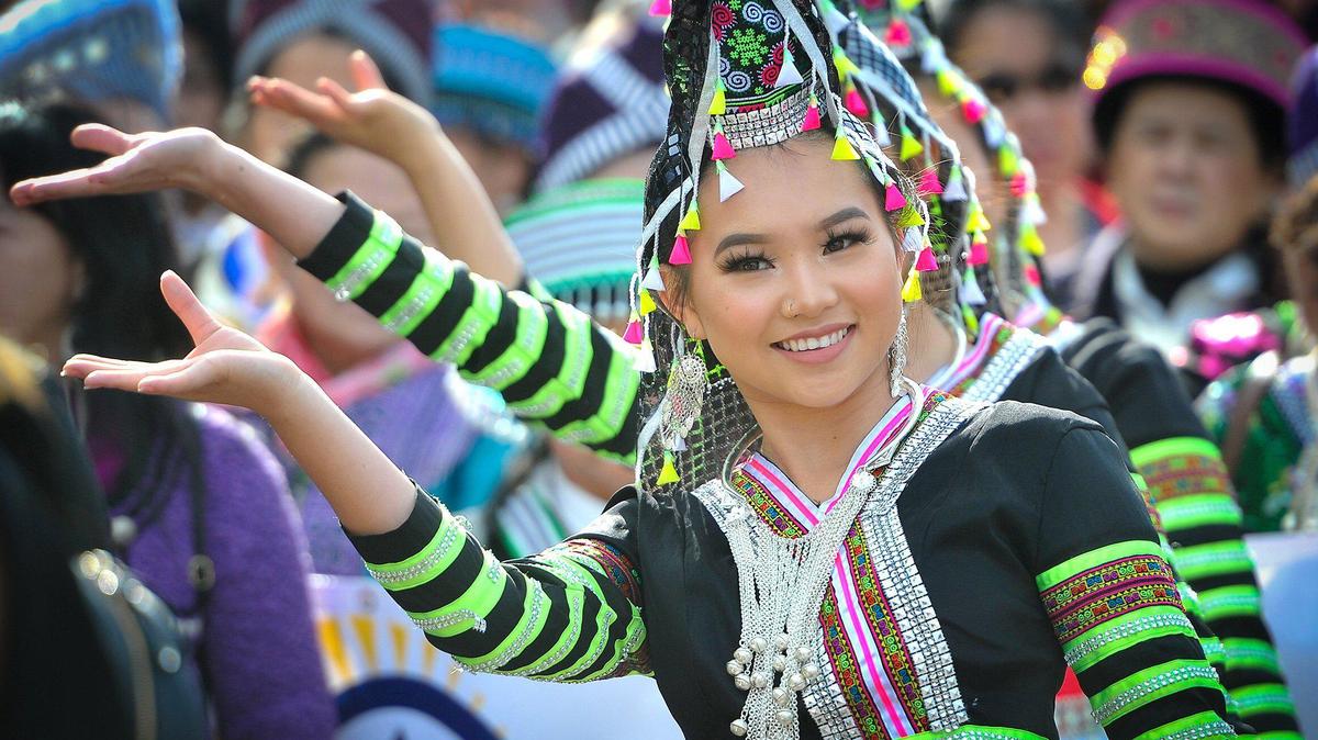 Kaitlyn Vang, 14, performs with her dance group during the parade kicking off the first day of the Hmong New Year celebration at the Fresno Fairgrounds, Thursday Dec. 26, 2019.