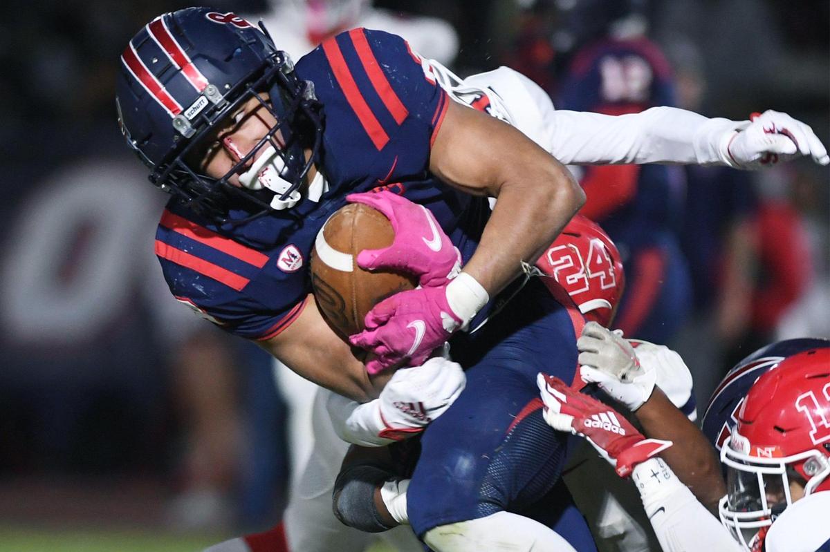 San Joaquin Memorial’s Brandon Ramirez carries the ball against Sanger Friday, Oct. 28, 2022 in Fresno. Memorial dominated Sanger to a 56-21 championship win in the County/Metro Athletic Conference.