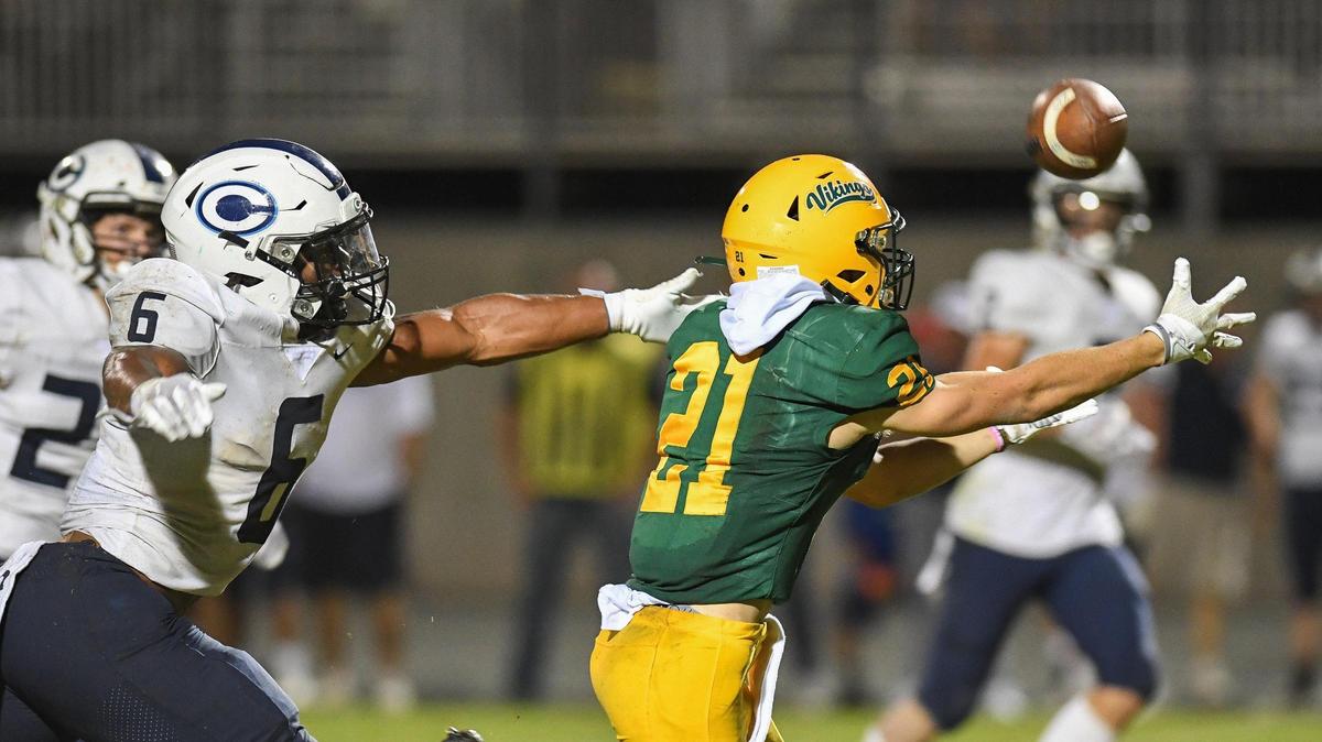Kingsburg’s Wyatt Boyd, right, reaches out to catch a pass down the middle while being pursued by Central Valley Christian’s Bryson Donelson during their game at Kingsburg on Friday, Oct. 14, 2022.