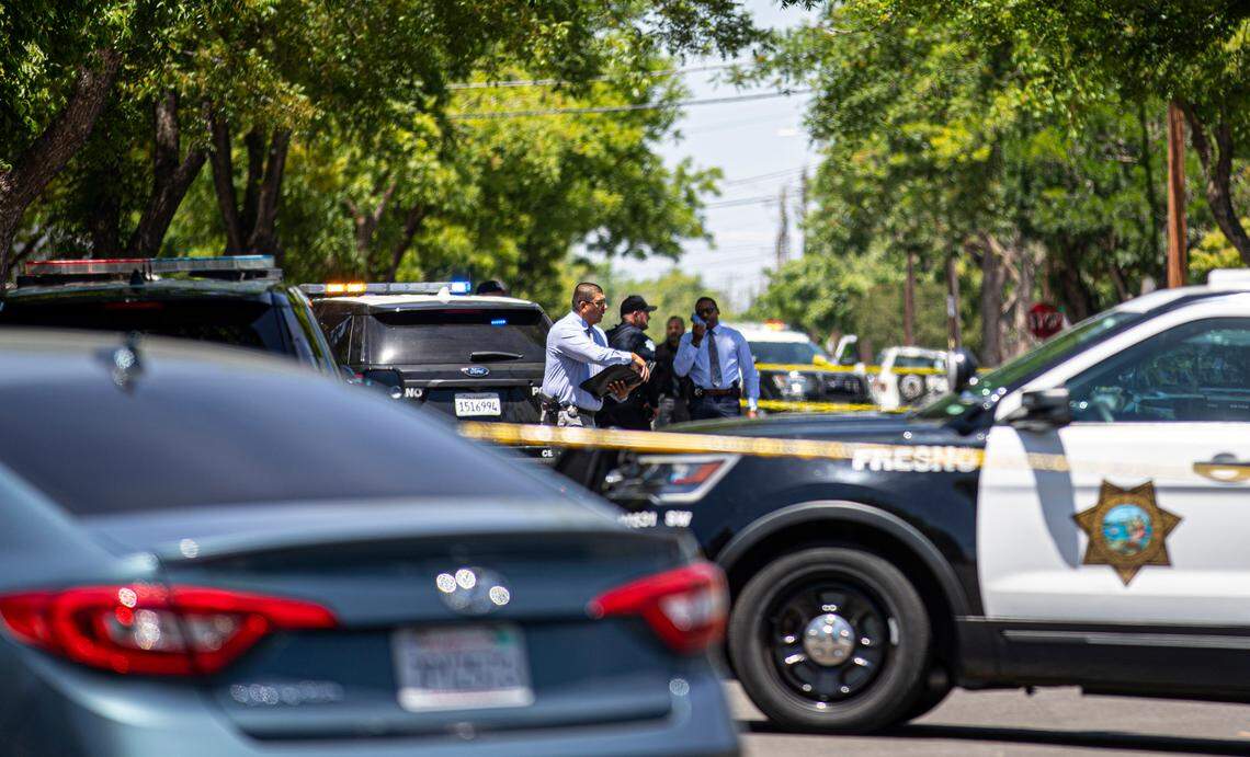 Detectives investigate a scene after an officer shot an armed suspect in central Fresno neighborhood on Thursday. May 19, 2022.
