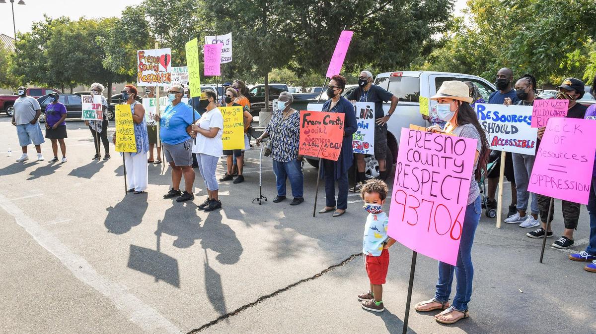 West Fresno residents gather outside the Department of Social Services building in west Fresno to protest the moving of service resources to the former Pelco facility in Clovis, on Wednesday, Sept. 15, 2021.