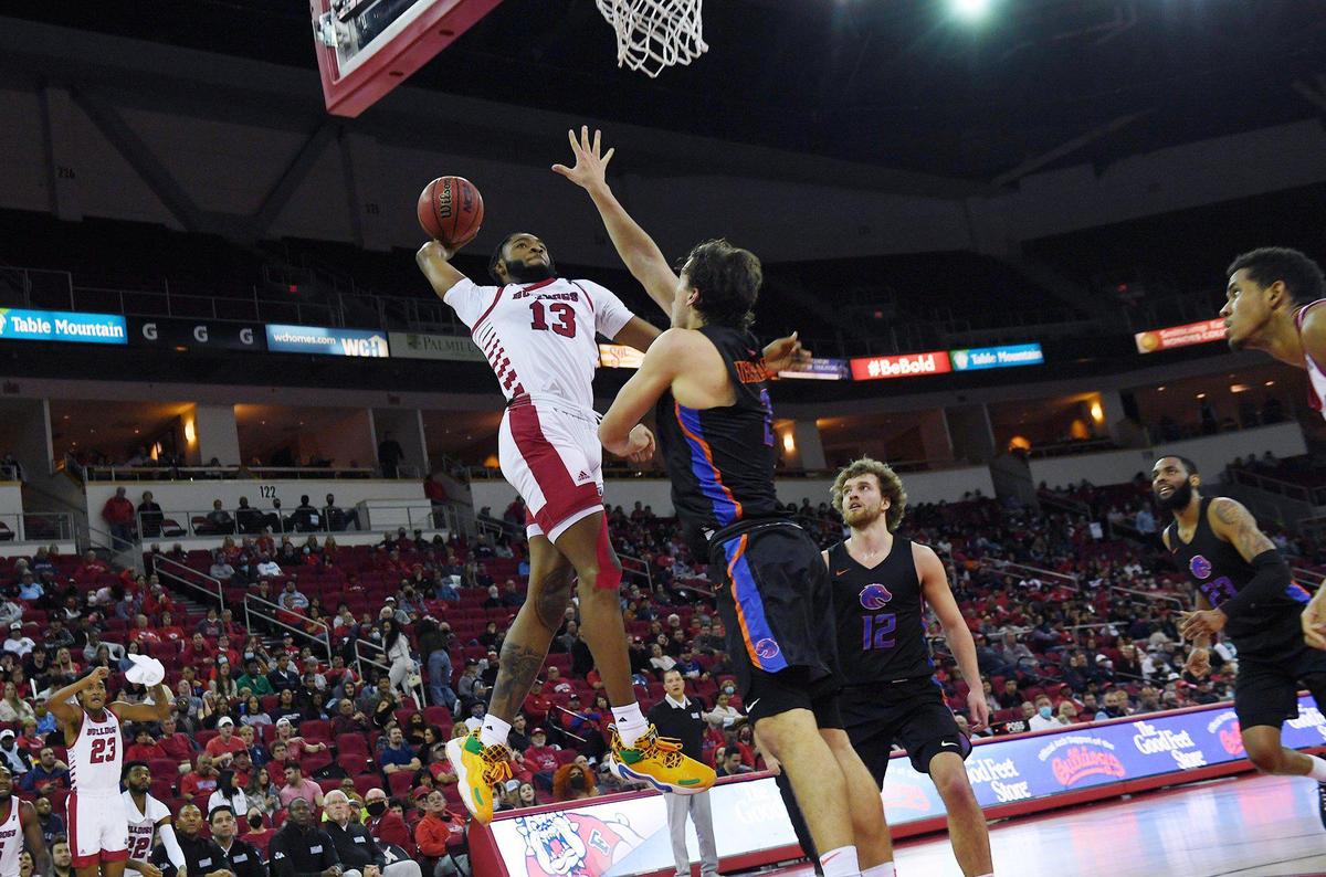 Fresno State’s Deon Stroud, left, dunks the ball with Boise State’s Tyson Degenhart to the right Friday, Jan. 28, 2022 in Fresno.