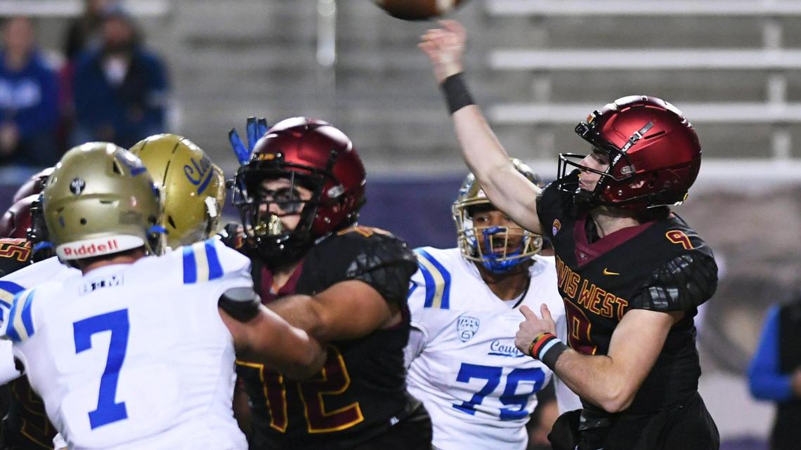 Clovis West quarterback Tyler Patrick, right, passes against Clovis High in first quarter action of a Central Section Division I quarterfinal Thursday, Nov. 10, 2022 in Clovis.