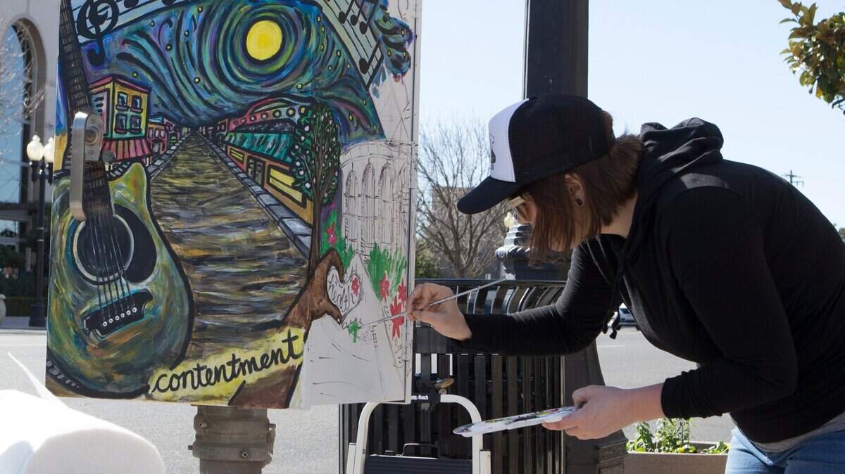Artist Jen Malloy is shown painting a utility box in Modesto. Leaders in Merced’s arts community hope to launch a similar project here.