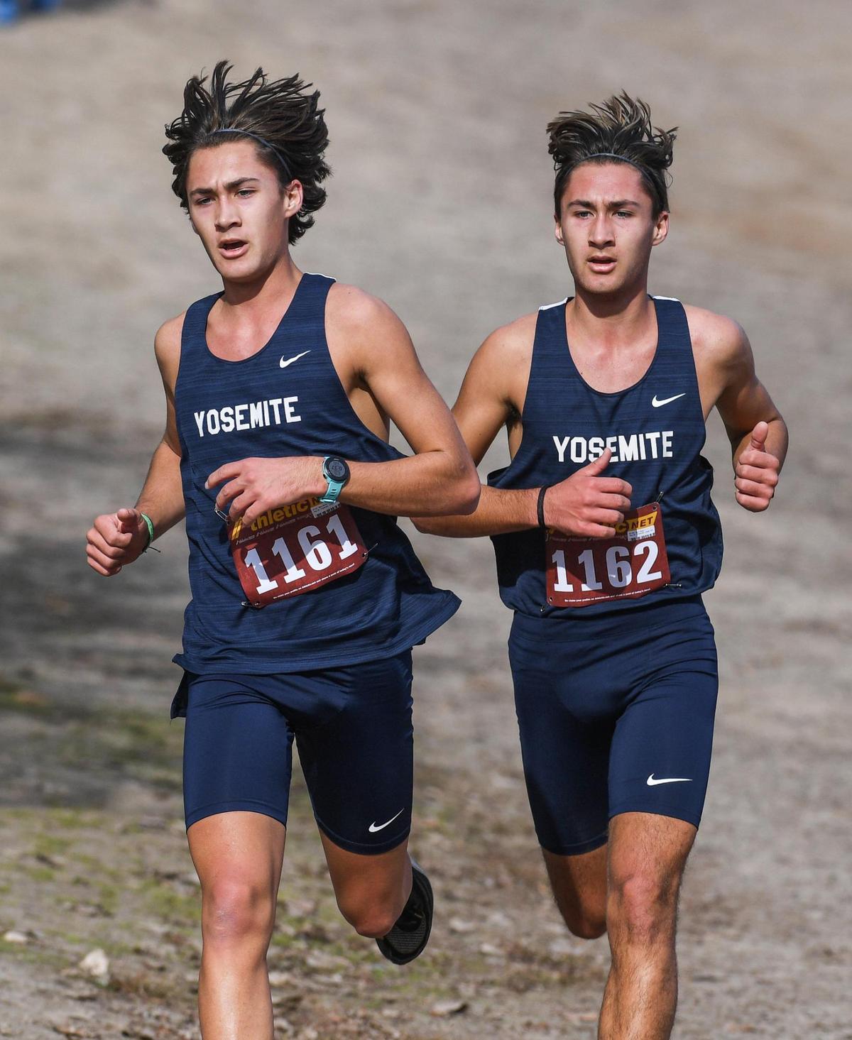 Twins Ben, left, and Jack Olney of Yosemite High take the lead going into the final mile of their Central Section boys Division V cross country race at Woodward Park in Fresno on Thursday, Nov. 17, 2022. They finished first and second respectively.