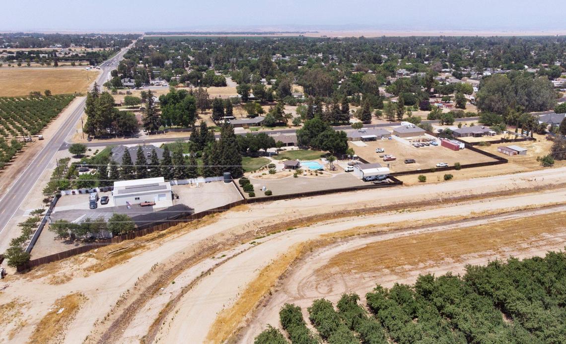 The currently-dry canal designated Lateral 6.2, bottom, runs south of the area of Madera Ranchos, top, with Road 36 to the left, photographed Thursday, June 17, 2021 at Madera Ranchos. Water is a critical source, compounded by housing developments in the area.