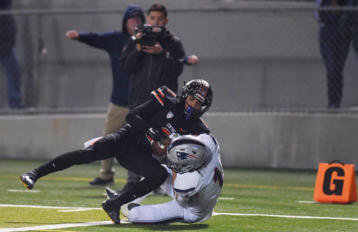 Liberty-Bakersfield wide receiver Austin Pratt, bottom, scores a touchdown covered by Central’s Elijah Lindsey, background, in the Central Section DI championship Friday, Nov. 26, 2021 in Fresno. Liberty led 35-7 at halftime,