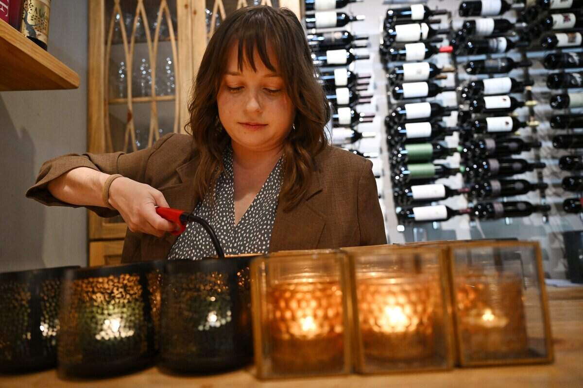 Kelsey Miller, Service Director at Trelio Food & Wine, begins lighting candles before service begins Thursday, June 11, 2026 in Clovis.
